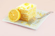 Lemon cake with a fork on a white plate.