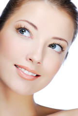 Close-up portrait of cheerful young adult girl - looking up.