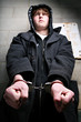 teen crime - portrait of young teenage in handcuffs