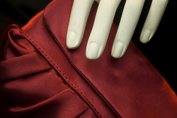 Mannequin hand on silk fashion purse handbag