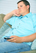 © visi.stock - Bored Male Holding TV Remote