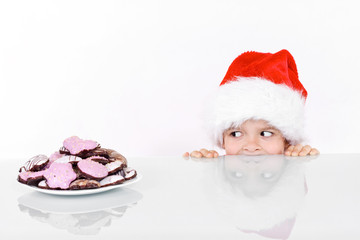 Boy peeking at the christmas gingerbread cookies