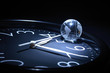 © cosma - Litte glassy globe on dark background with watch
