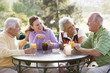 © Monkey Business - Friends Enjoying A Beverage By A Golf Course