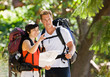 © AVAVA - Couple with backpacks looking at map
