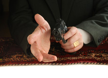 Hands Of Man With A Pistol