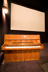 Wall Mural - empty cinema auditorium and a piano