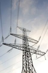 Electricity pole and wires against blue sky