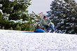 © Mehmet Dilsiz - Mother and Son Sledding down the Hill