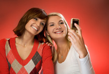 Two Beautiful Girls Making Self-portrait Using Mobile Phone