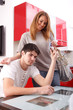 © Bocos Benedict - young man giving several credit cards to his girlfriend