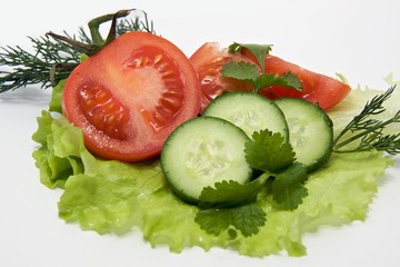 tomatoes and cucumber on the salad leaf