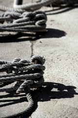 Wall Mural - Boat bollard, ropes and knots in mediterranean harbor