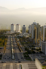 Wall Mural - Wide boulevard on sunrise with mountains as a background