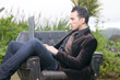© Tandem - beautiful man with laptop sitting in an armchair in the forest