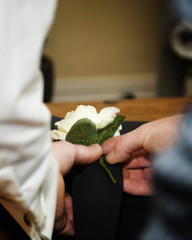 Twp hands fixing buttonhole to jacket