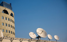 Satellite Antennas On A Roof Of Modern Office Building