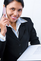 Wall Mural - Businesswoman listening to her cell phone while holding document