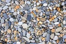 A Variety Of Smooth Stones On Beach
