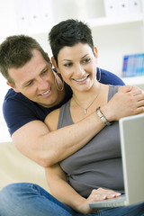 Poster - Young couple with computer