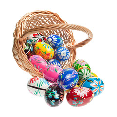 Hand crafted wooden Easter Eggs spilling out of a basket