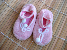 Children's Bootees On Wooden Rug