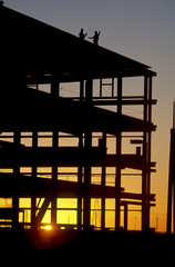 silhouette workers at construction site