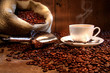 Leinwandbild Motiv Coffee cup with burlap sack of roasted beans