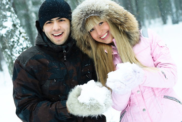 happy young couple in winter park