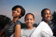 © logoboom - Three beautiful smiling teenage African American girls outdoors