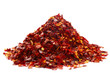 a pile of crushed chillies on white, bright red color