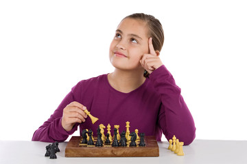 Wall Mural - Attractive little girl playing chess