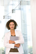 © carlosseller - Portrait of attractive business woman holding folder