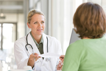 attractive young caring doctor talking to patient