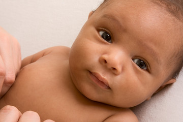 ethnic baby boy lying down