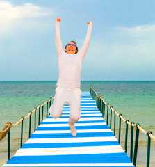 Poster - Man jumping in ecstasy on a pier