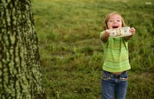 Beautifull Happy Little Girl With Dollar Note