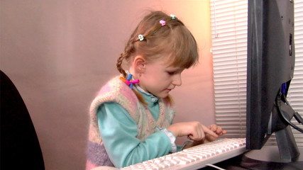 little girl work at computer