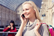 © Lena S. - Girl speaks by phone with a lot of shopping bags