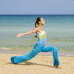 Wall Mural - Woman exercising on a beach