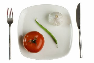 Plate with tomato green bean and garlic. Isolated on white.