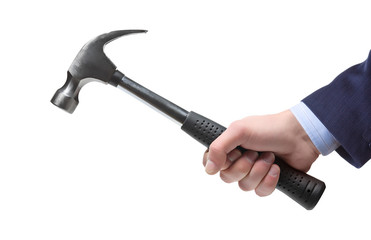 a businessman’s hand holding a hammer