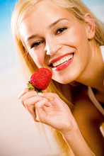 Young Beautiful Happy Smiling Blond Woman With Strawberry