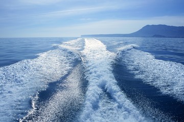 Boat white wake on the blue ocean sea