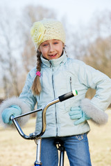 Wall Mural - Little girl riding bicycle outdoors