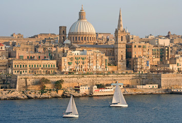 Yachts sailing by a harbour