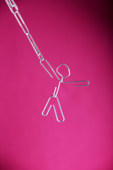 A paper clip man hanging