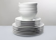 Stack of White Dishes on Monochromatic Background