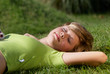 © Andriy Petrenko - The young girl having a rest on a grass in park