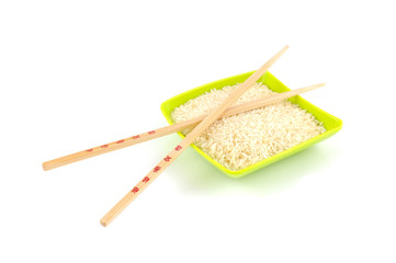 Chinese sticks on green bowl with rice